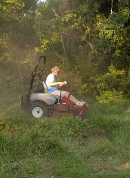 Dave Perry on riding mover on St. Augustine grass on Gulf Coast.