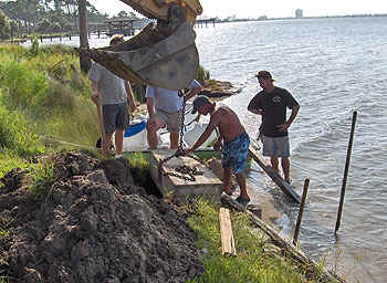 lowering a concrete section by backhoe
