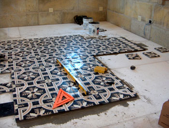 black pattern cement tile in master bedroom