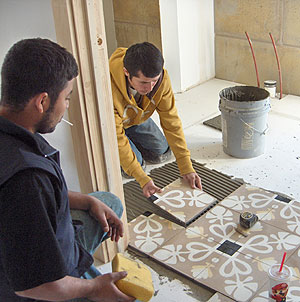 Placing bathroom cement tile.