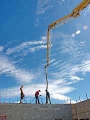 Pumping concrete into the hollow cavity of the concrete blocks
