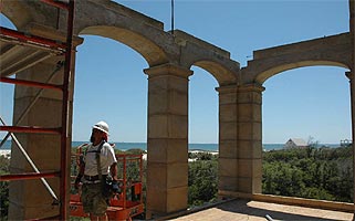 Workmen on upper porch 