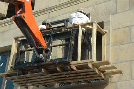workmen installing dade county code storm windows