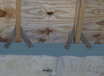 Close up of wind straps on engineered trusses