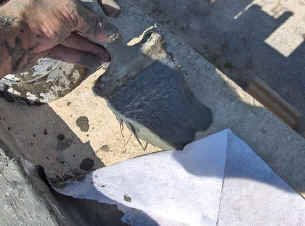 Applying HydroStop with a paint brush