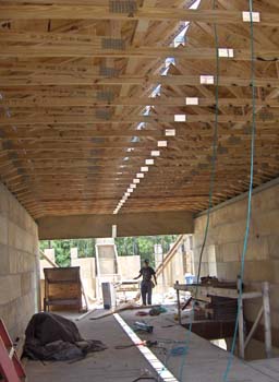 Engineered roof trusses with hurricane straps